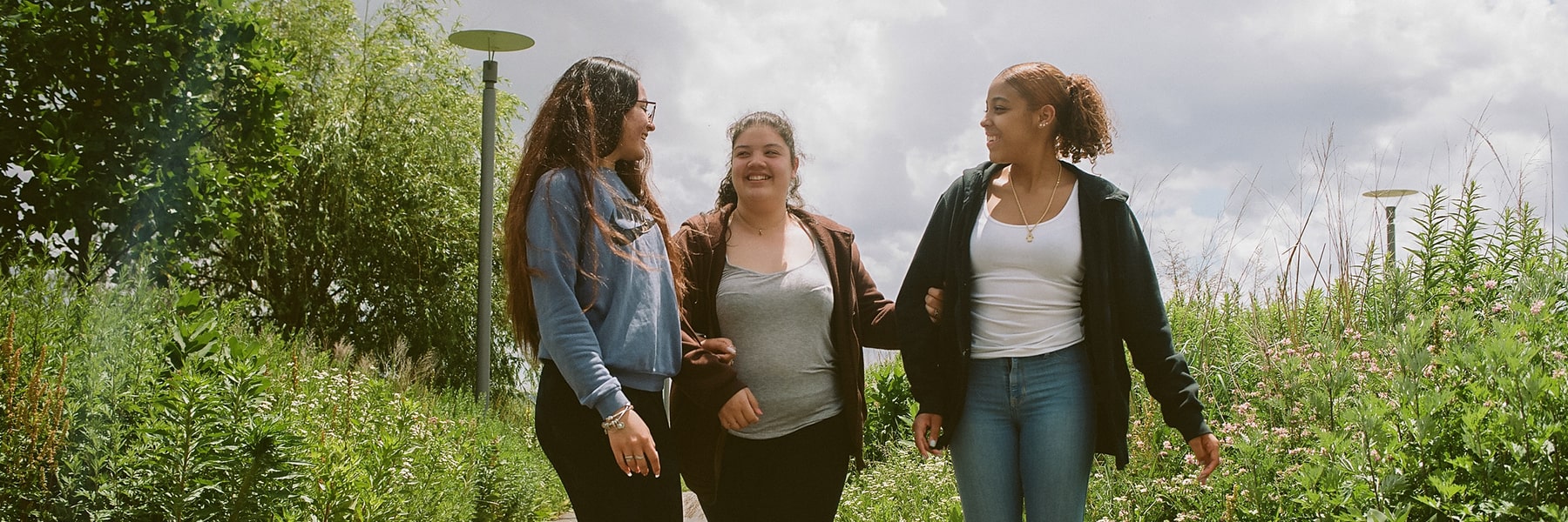 3 girls walk on the Harborwalk.
