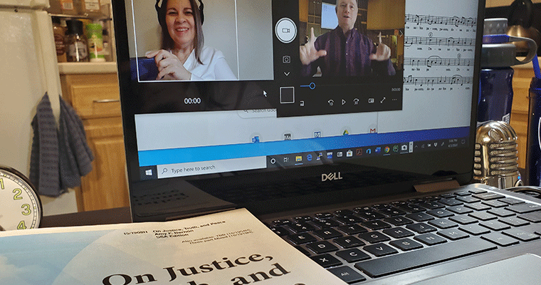 A laptop showing two people practicing music on Zoom