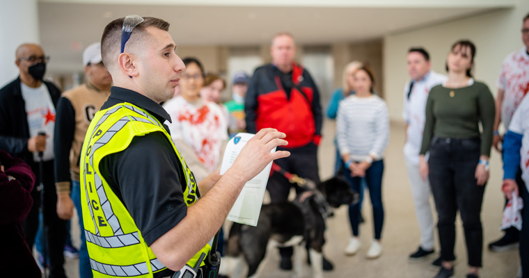 Police officer speakers to volunteers at the emergency preparedness exercise