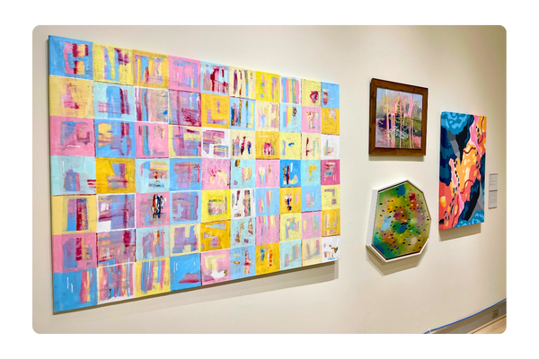 Pastel patchwork painting hanging on gallery wall